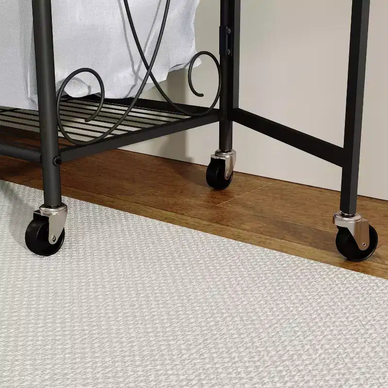 Multifunctional storage rack with hanging rods and shelves, metal basket with wheels, suitable for bathrooms, laundry rooms, and bedrooms.