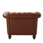 Poltrona Chesterfield Zeus e Ruta con braccioli arrotolati, finiture con borchie e gambe in legno massello